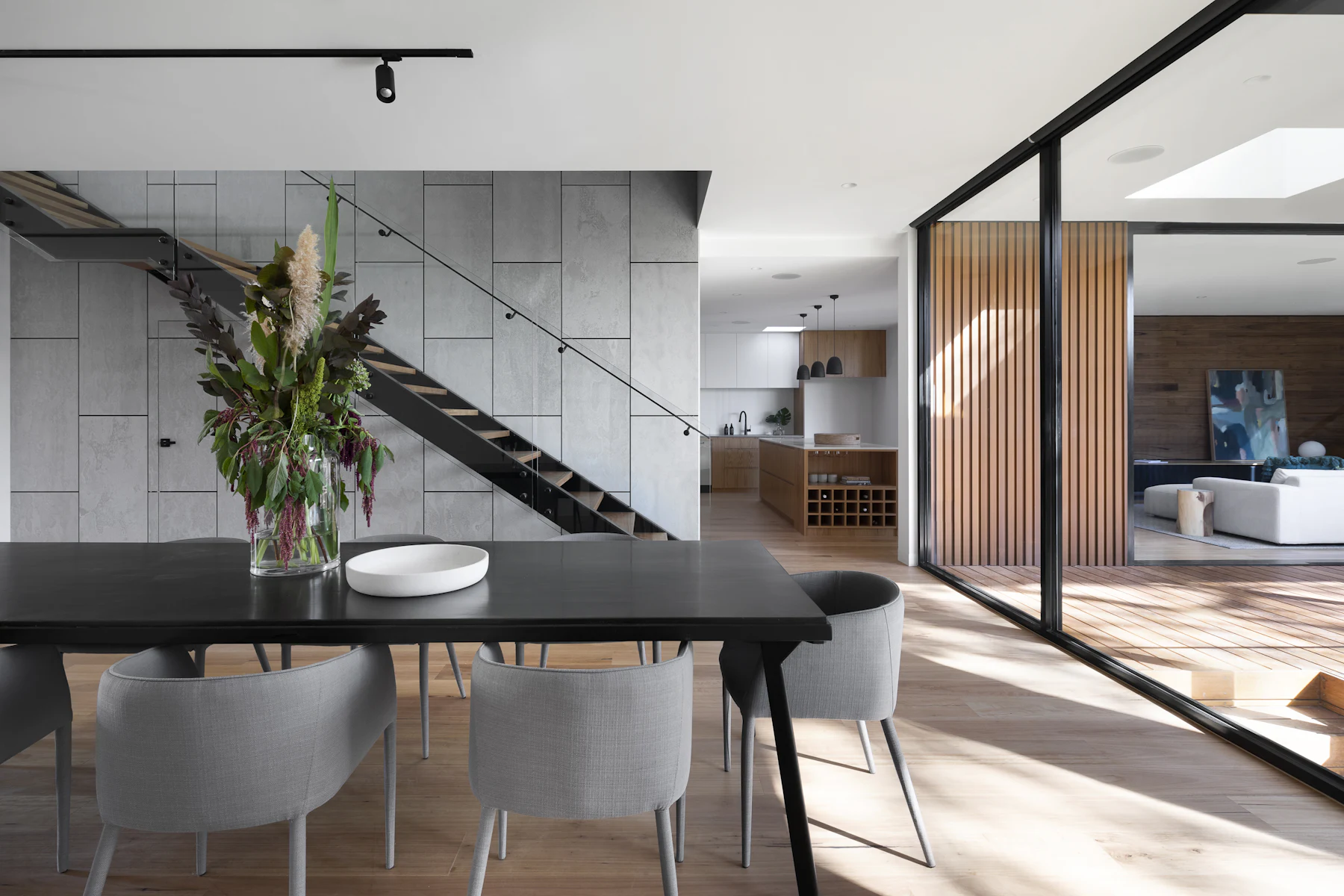 Dining table beneath an open stair