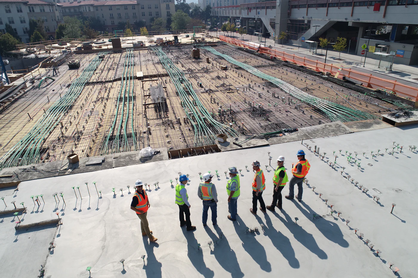 Surveyors walking a cleared development site