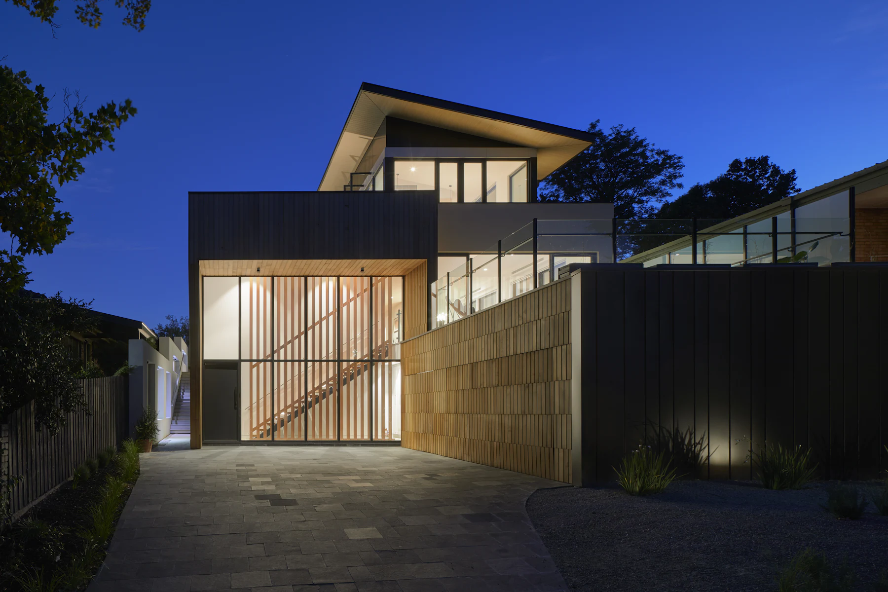 The Larches: timber house lit at dusk